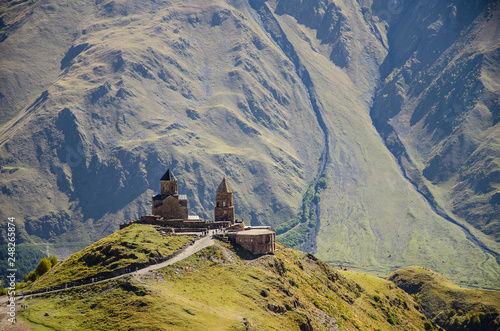 Holy Trinity Church in Kazbegi mountain range near Stepantsminda view Caucasus mountains in the background