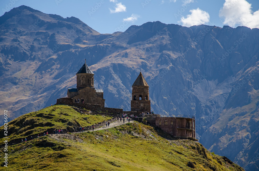 Close view of Holy Trinity Church in Kazbegi mountain range near Stepantsminda view Caucasus mountains in the background Close view of Holy Trinity Church in Kazbegi mountain range near Stepantsminda view Caucasus mountains in the background