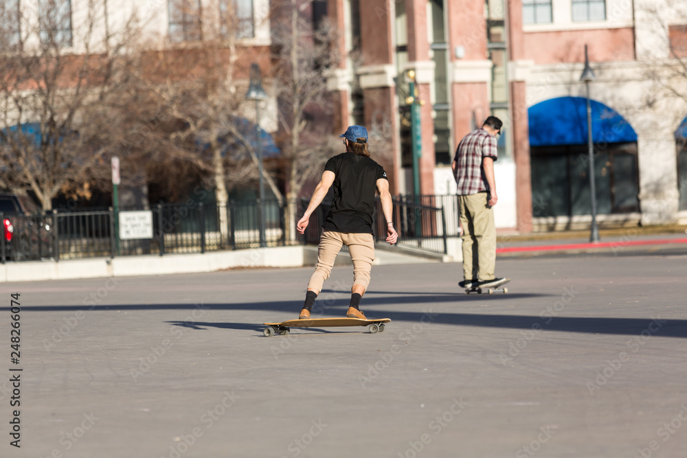 Person riding a skate board in an urban asphalt park