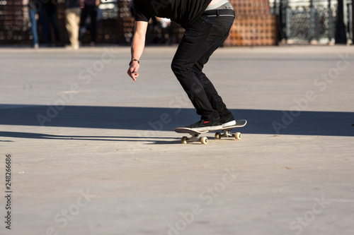 Person riding a skate board in an urban asphalt park © ecummings00