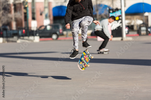 Person riding a skate board in an urban asphalt park