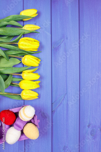 Bouquet of fresh tulips and Easter eggs wrapped woolen string, Easter decoration, place for text