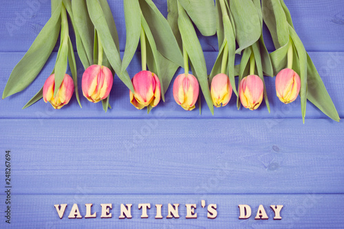 Fresh tulips for Valentines Day, copy space for text on boards. Vintage photo