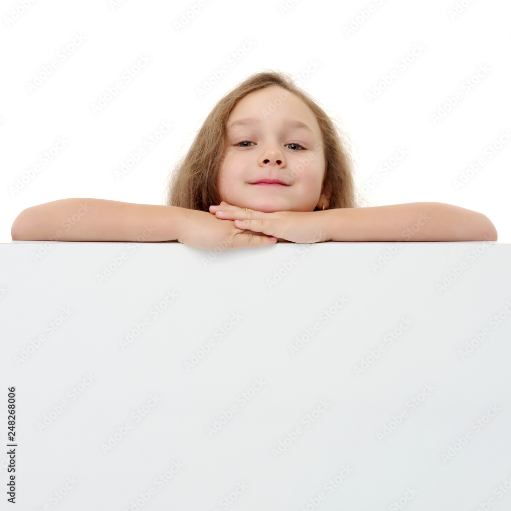 A little girl is looking from behind an empty banner. A little girl is looking from behind an empty banner.