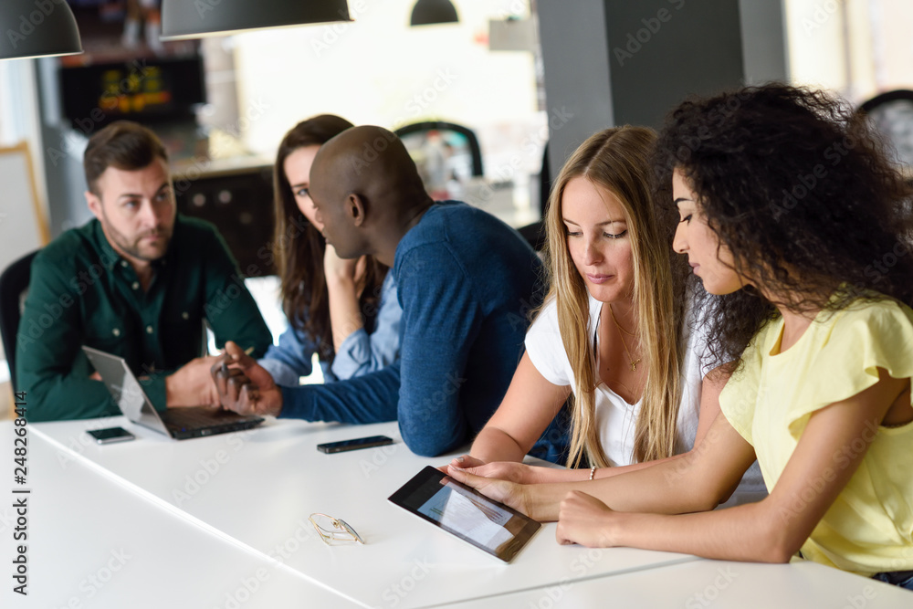 Multi-ethnic group of young people studying with laptop computer Multi-ethnic group of young people studying with laptop computer