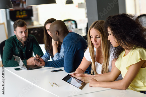 Multi-ethnic group of young people studying with laptop computer