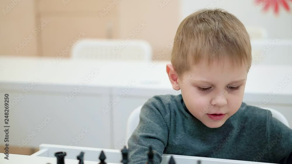 Portrait of a boy playing chess. Portrait of a boy playing chess.