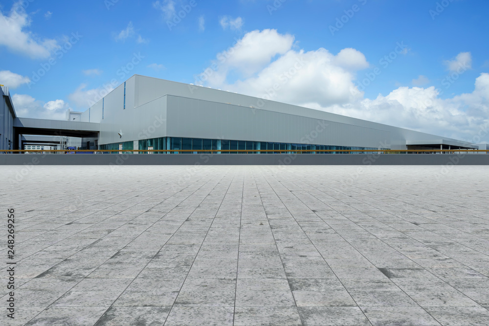 Empty square floor tiles and modern factory buildings and warehouses.. Empty square floor tiles and modern factory buildings and warehouses..