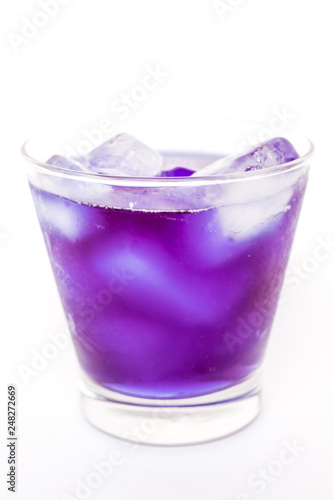 Butterfly pea juice on ice in transparent glass isolated on white background 