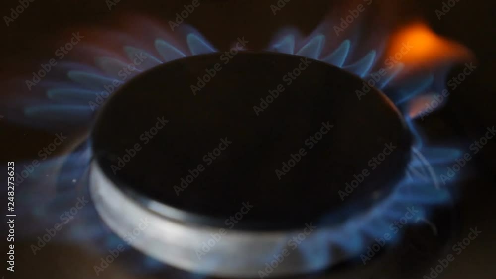 Natural gas inflammation in stove burner. Slow motion. Turns on gas