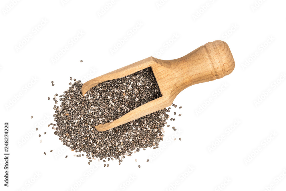 Small wooden scoop with chia seeds seen directly from above and isolated on white background