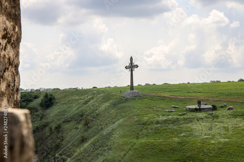 Christian cross on hillside. Crucifixion religious concept.
