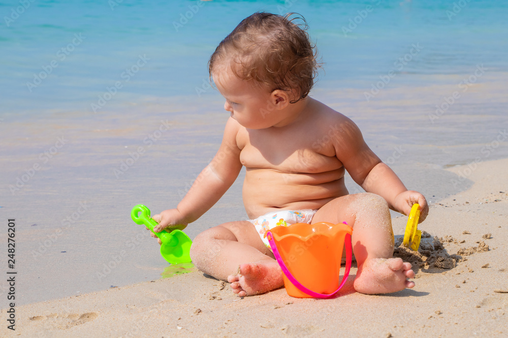 Happy child playing in summer on the blue sea Happy child playing in summer on the blue sea