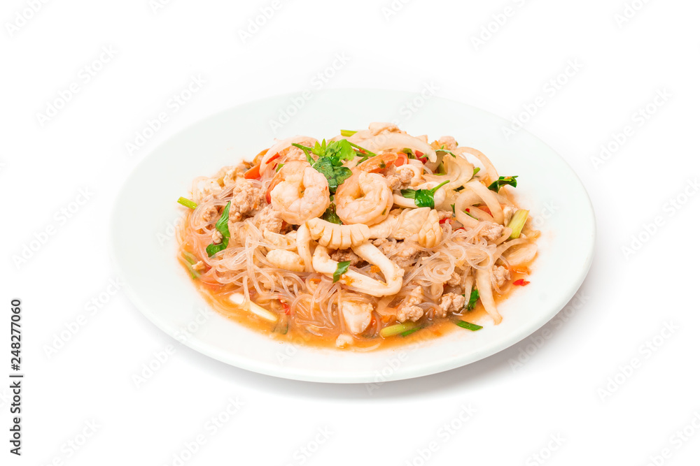 spicy noodle salad with shrimp and squid on white plate spicy noodle salad with shrimp and squid on white plate