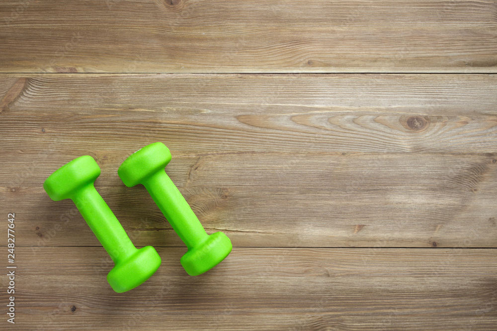 dumbbells on wooden background dumbbells on wooden background