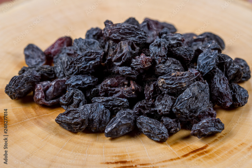 Blue raisins on a wooden background Blue raisins on a wooden background