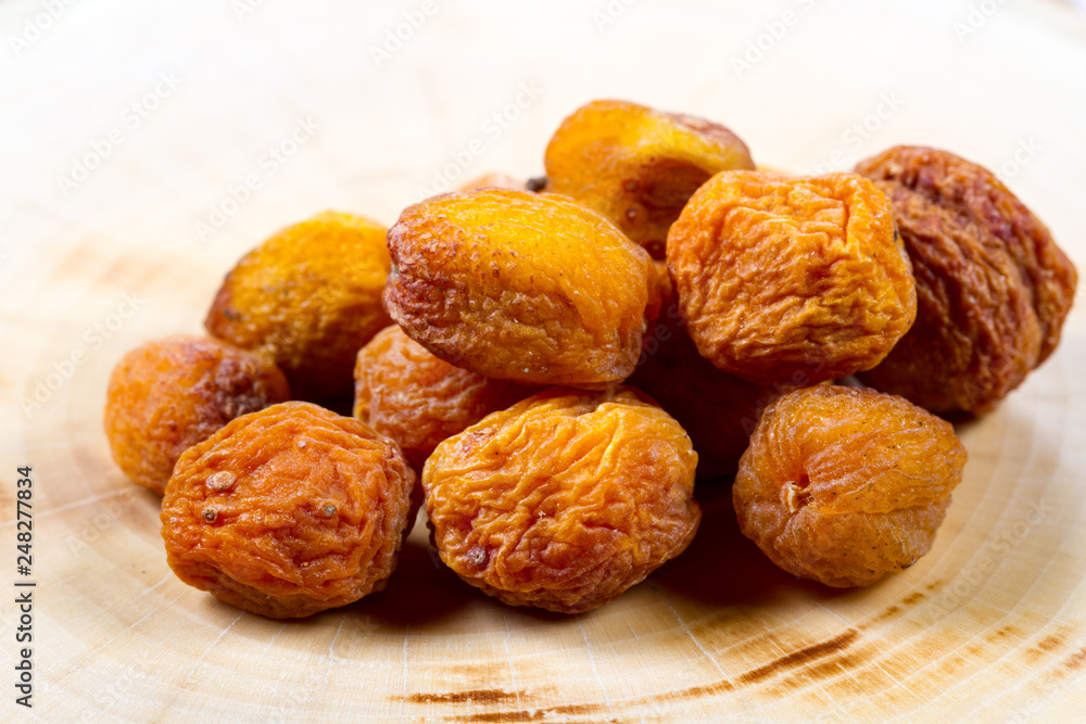 Dried apricots on a wooden background Dried apricots on a wooden background