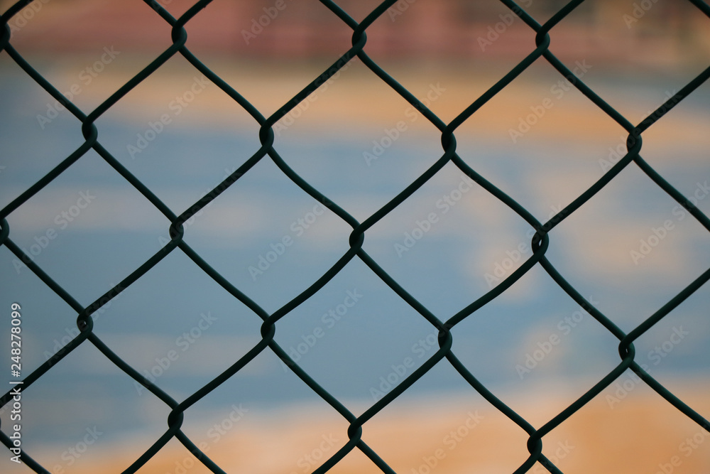 Wire mesh fence colosed up iron steel with color background Wire mesh fence colosed up iron steel with color background