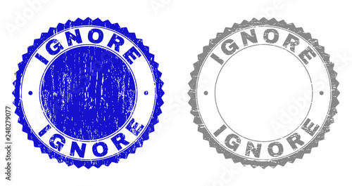 Grunge IGNORE stamp seals isolated on a white background. Rosette seals with grunge texture in blue and grey colors. Vector rubber stamp imitation of IGNORE caption inside round rosette.