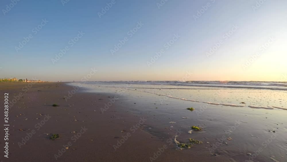Riccione, Italy. Sea waves along the seashore at sunrise in summer Riccione, Italy. Sea waves along the seashore at sunrise in summer
