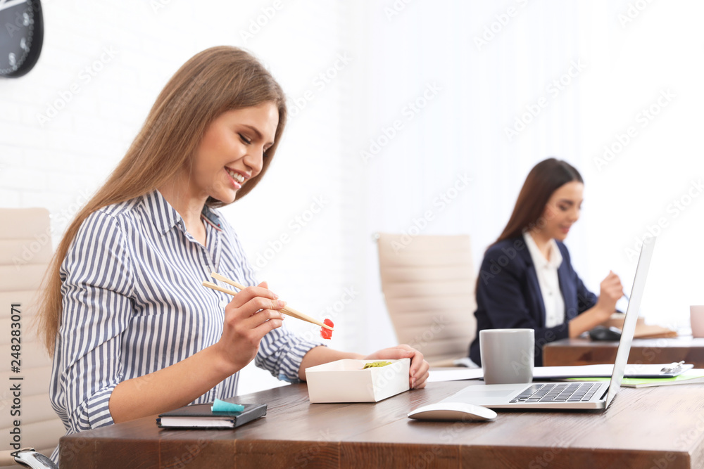 Office employees having lunch at workplace. Food delivery Office employees having lunch at workplace. Food delivery