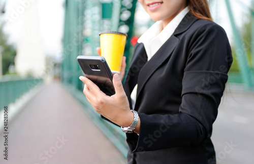 Woman enjoy with her smartphone for social network and using coffee cup in hand with relax time,Selective focus