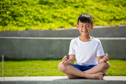 Little athlete boy playing exercise or yoga outdoor, Stretching muscle gymnastic