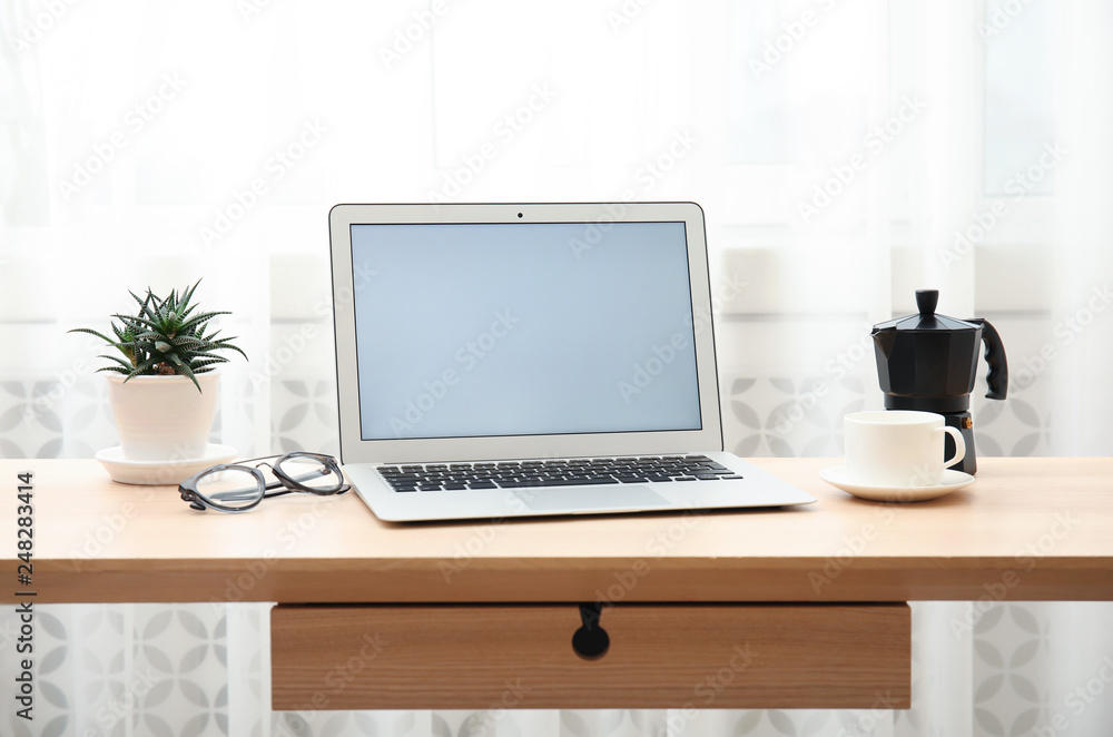 Cozy blogger workplace with laptop at home Cozy blogger workplace with laptop at home