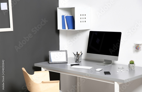 Modern interior of workplace with computer and accessories © New Africa