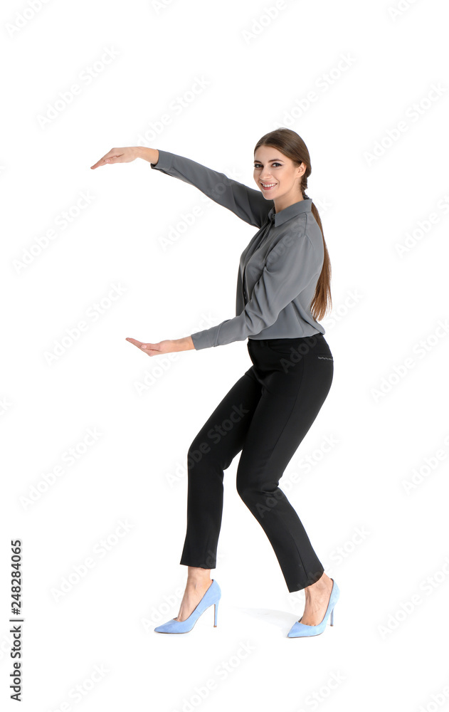 Young woman with magnet attracting people on white background