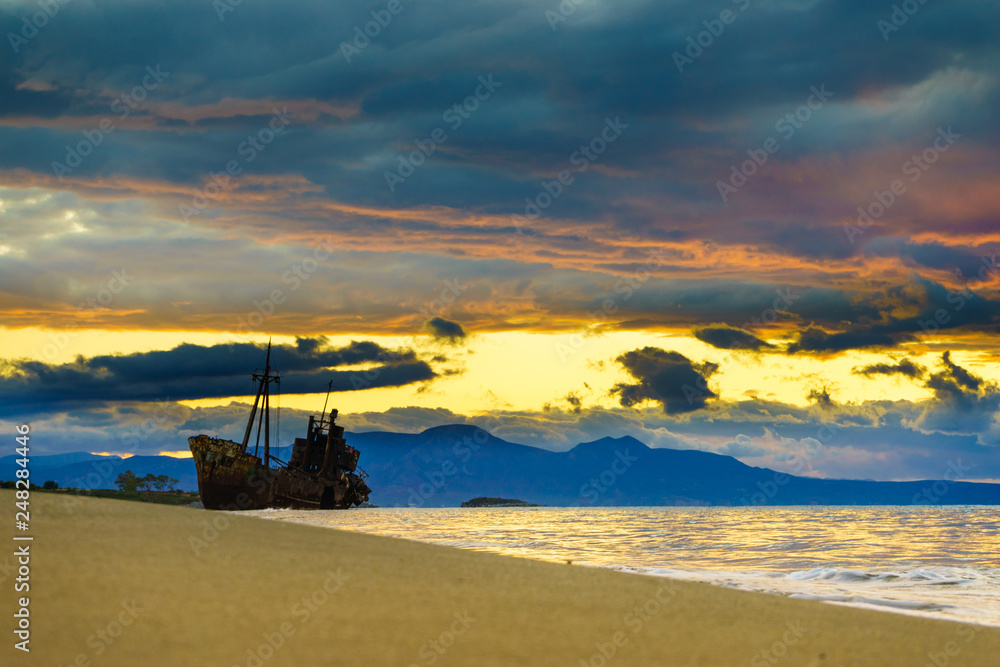 Fototapeta premium Rusty broken shipwreck on sea shore