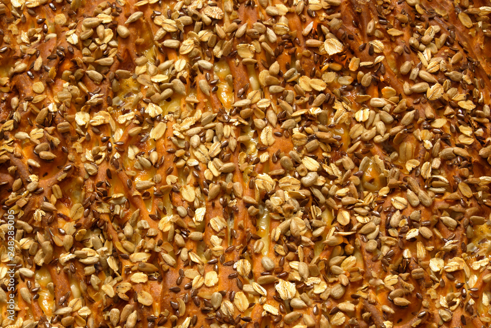 Close up top view of fresh cooked pie topping with sunflower and flax seeds and oats background Close up top view of fresh cooked pie topping with sunflower and flax seeds and oats background