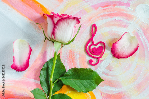 Rose with a decorative heart in the shape of a treble clef with pink felt.