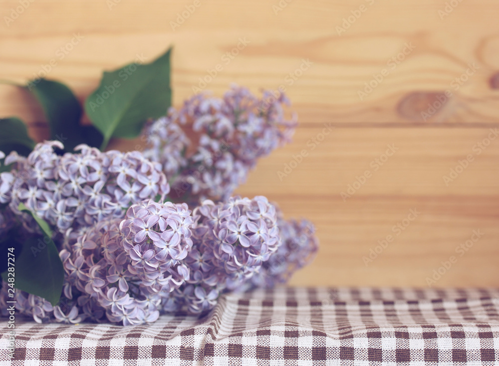 branch of purple lilac on the table, place for text. branch of purple lilac on the table, place for text.
