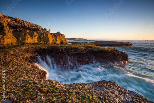 Wide angle landscape image of the dramatic sandstone rock formations along the coastline of Arniston in th Western Cape of South Africa. photo