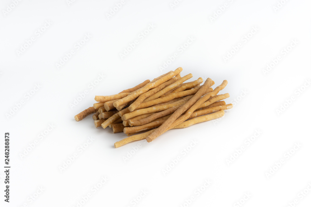 Natural toothbrush Miswak (Kayu Sugi) on white background with selective focus. It is a teeth cleaning twig made from the Salvadora persica tree and also know as miswaak, siwak, Sugi or sewak