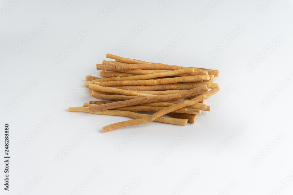 Natural toothbrush Miswak (Kayu Sugi) on white background with selective focus. It is a teeth cleaning twig made from the Salvadora persica tree and also know as miswaak, siwak, Sugi or sewak Natural toothbrush Miswak (Kayu Sugi) on white background with selective focus. It is a teeth cleaning twig made from the Salvadora persica tree and also know as miswaak, siwak, Sugi or sewak