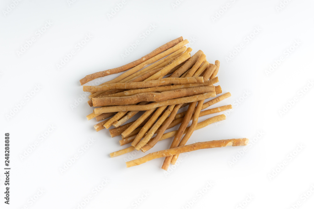 Natural toothbrush Miswak (Kayu Sugi) on white background with selective focus. It is a teeth cleaning twig made from the Salvadora persica tree and also know as miswaak, siwak, Sugi or sewak