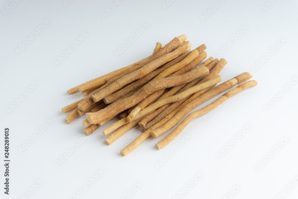 Natural toothbrush Miswak (Kayu Sugi) on white background with selective focus. It is a teeth cleaning twig made from the Salvadora persica tree and also know as miswaak, siwak, Sugi or sewak