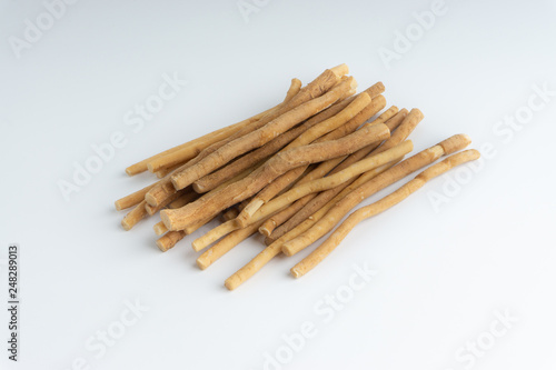 Natural toothbrush Miswak (Kayu Sugi) on white background with selective focus. It is a teeth cleaning twig made from the Salvadora persica tree and also know as miswaak, siwak, Sugi or sewak