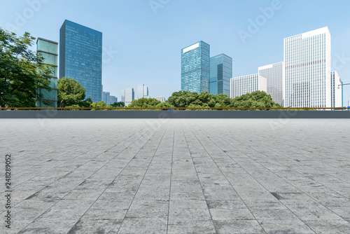 Empty Plaza floor tiles and the skyline of modern urban buildings in Hangzhou..