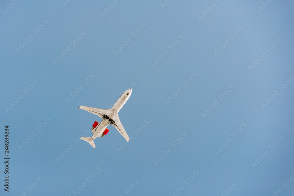 A jet airplaine is flying in the sky at sunset A jet airplaine is flying in the sky at sunset