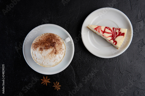 Cup of cappuchino coffee with cheesecake. Copy space, top view, flat lay