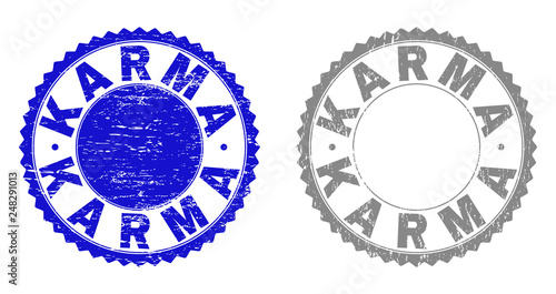 Grunge KARMA stamp seals isolated on a white background. Rosette seals with grunge texture in blue and gray colors. Vector rubber stamp imitation of KARMA caption inside round rosette.