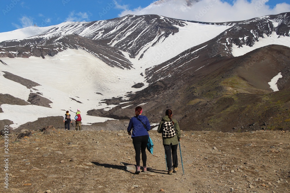 Hikers are on the route. Avachinsky volcano is visible in the background.