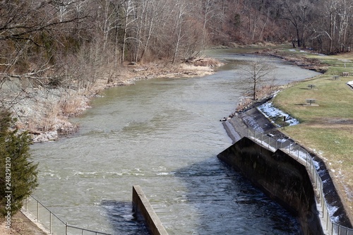 The water from the dam flow into the creek. 