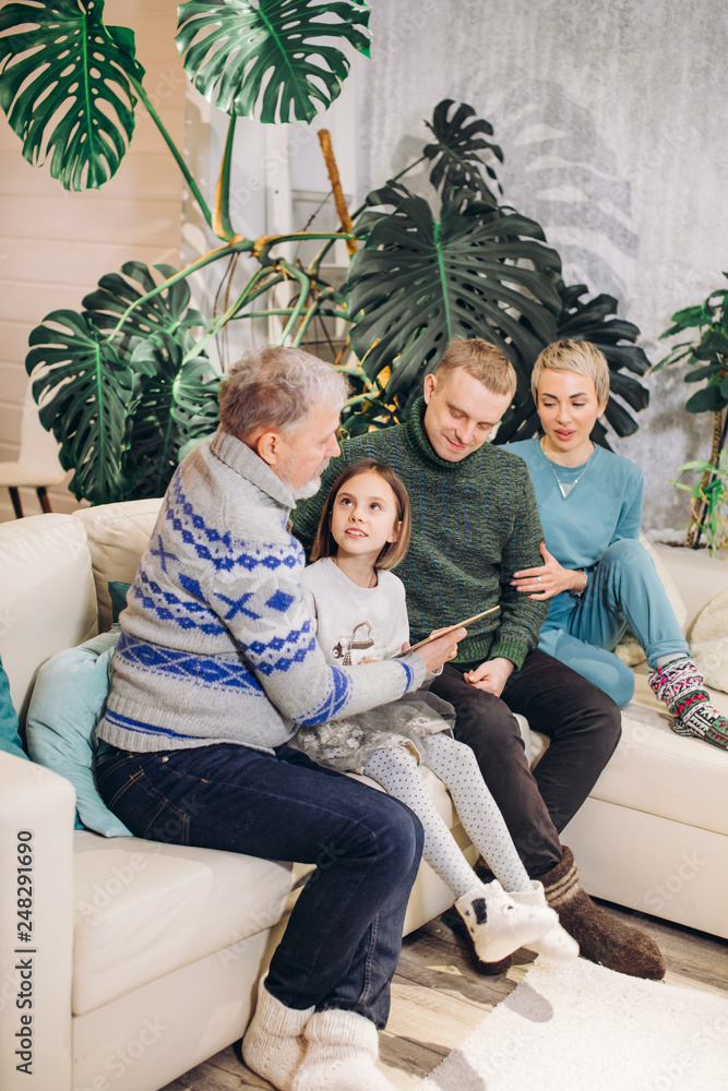 granfather is reading a fairy taile to his graddaughter. side view photo. education granfather is reading a fairy taile to his graddaughter. side view photo. education