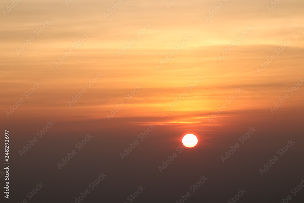 Beautiful sunset or sunrise sky above clouds with dramatic light.