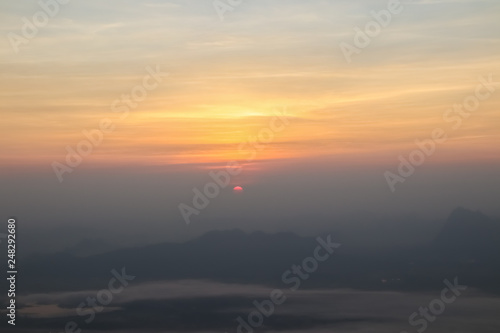 Beautiful sunset or sunrise sky above clouds with dramatic light. © sukanda