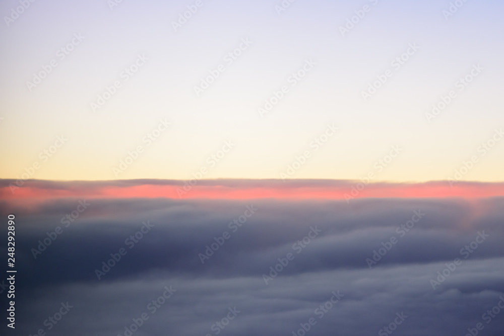 The blue skyline with cloudy in sunrise time, view from window on the plane.